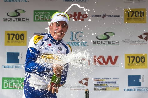  Jelle Wallays (Topsport Vlaanderen-Baloise) celebrates and sprays champagne on the podium during the 70th edition at Houtland’s Circuit, Belgium.